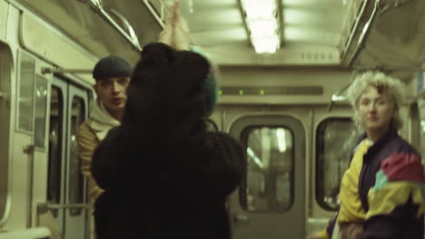 Stylish-Girl-Dancing-with-Team-in-Subway-Train